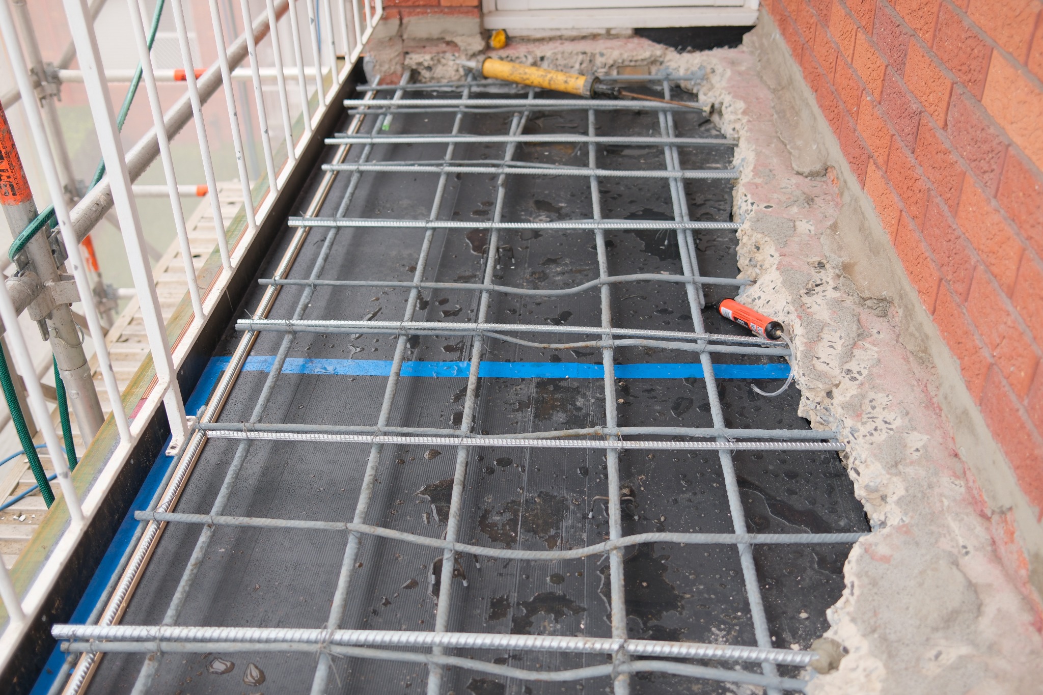 New reinforcement and formwork prepared for a reconstructed concrete balcony slab