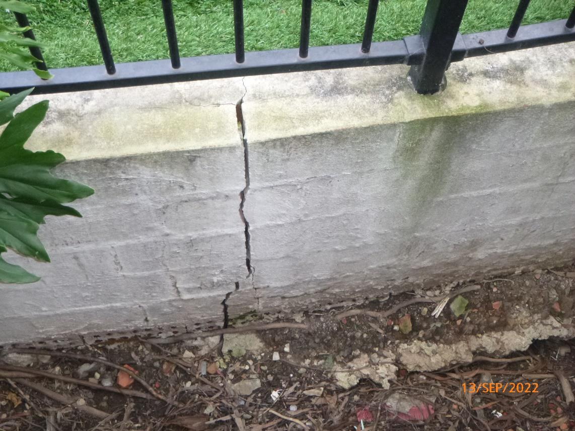 Vertical cracking through a masonry retaining wall